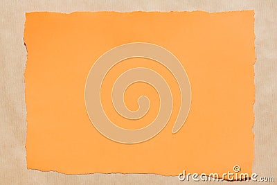 Orange piece of torn paper on recycled paper background texture Stock Photo