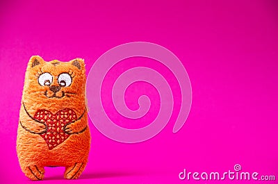 Orange plush cat with red heart so cute on the pink background Stock Photo