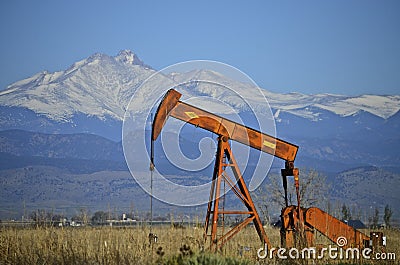 Orange Pump Jack Oil Well and Longs Peak Stock Photo