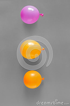 Orange purple balloons gray background Stock Photo