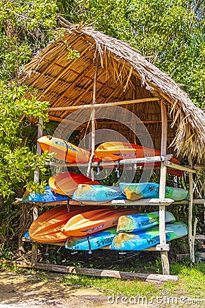 Orange red blue canoes Muyil Lagoon boat trip in Mexico Editorial Stock Photo