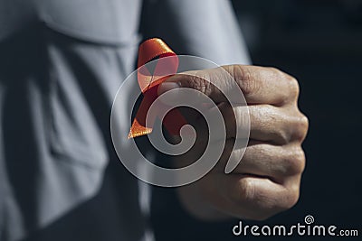 Orange ribbon in support of multiple sclerosis Stock Photo