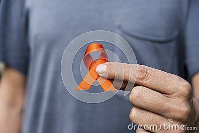 Orange ribbon in support of multiple sclerosis Stock Photo