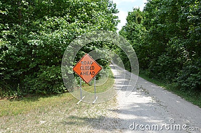 Orange road closed sign with path or trail Stock Photo