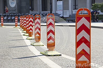 Orange road dividers. Curved line of dividing posts on the double road marking line Stock Photo