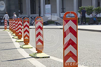 Orange road dividers. Curved line of dividing posts on the double road marking line Stock Photo