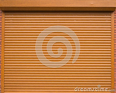 Orange roll gates with bricks on the sides Stock Photo