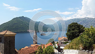 Orange roofs of Perast town and small islands - bay of Kotor in Montenegro Stock Photo