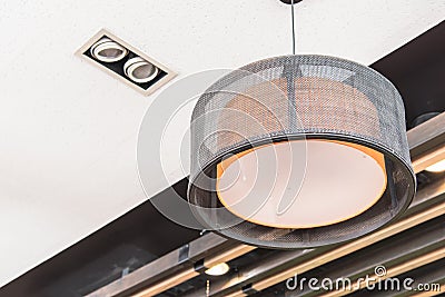 Orange round stylish lampshades hang from ceiling Stock Photo