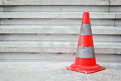 Orange safety pylon on stairs Stock Photo