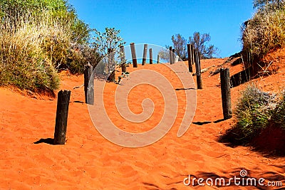 Orange sandy path going uphill in Australian outback Stock Photo