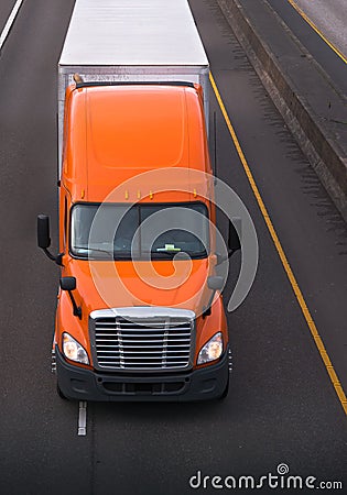 Orange semi truck with dry van trailer on the road top view Stock Photo