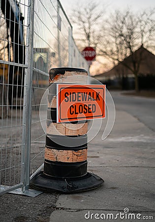 Sidewalk closed orange sign on traffic cone Stock Photo