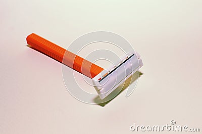 Orange single-blade razor on white background Stock Photo