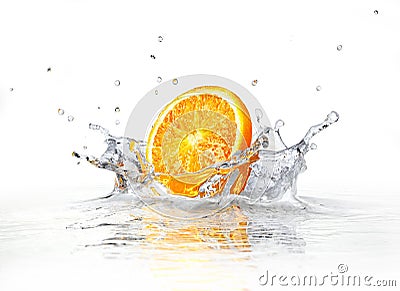 Orange slice falling and splashing into clear water. Stock Photo