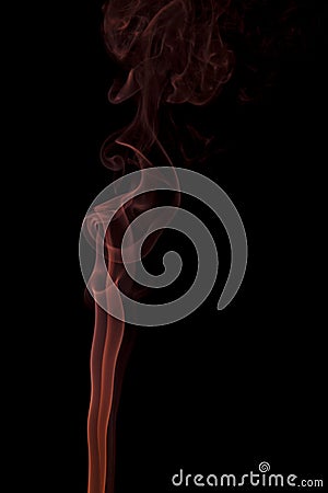 Orange smoke swirling on a black background Stock Photo