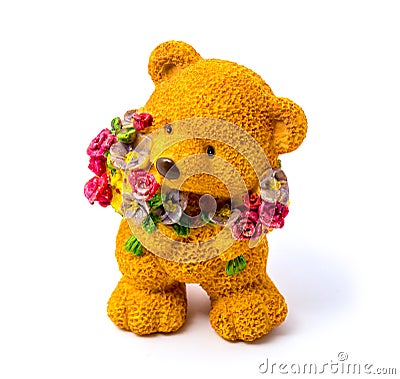 Orange statuette of a bear with flowers isolated on a white background Stock Photo