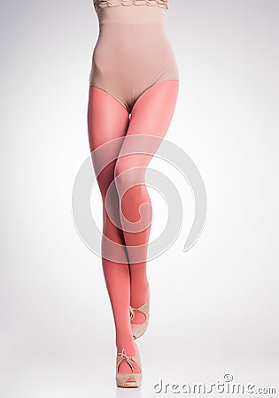 Orange stockings on woman legs on grey Stock Photo