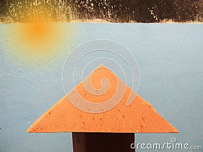 Orange sunbeam and roof on blue wall Stock Photo