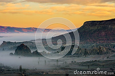 Orange sunset and mystical fog over the Cappadocia, Turkey Stock Photo