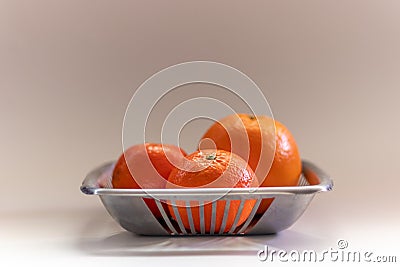 Orange tangerine basket in a plain grey background Stock Photo