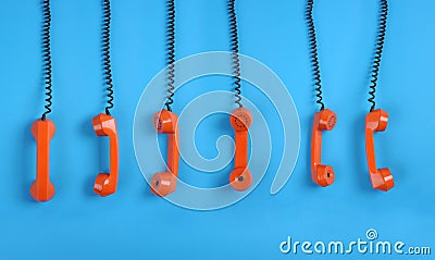 Orange telephones over blue background Stock Photo