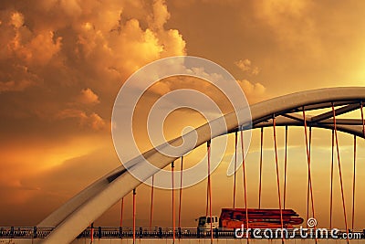 Orange truck on a bridge in sunset light Stock Photo