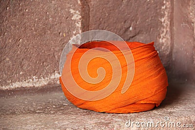 An orange Turban laying on the streets Stock Photo