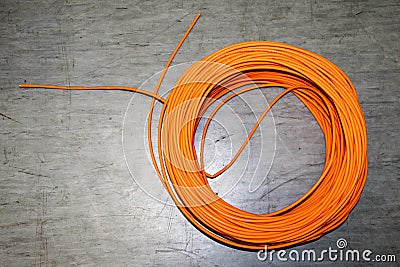 Orange twisted pair cable isolated on floor of data center Stock Photo