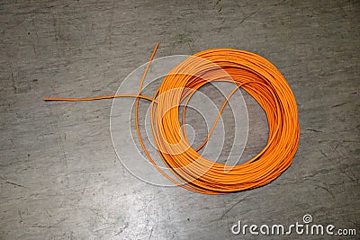 Orange twisted pair cable isolated on floor of data center Stock Photo