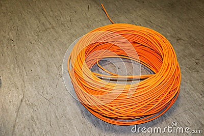 Orange twisted pair cable isolated on floor of data center Stock Photo