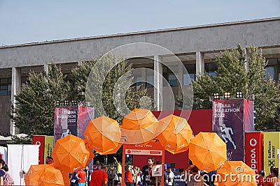 Orange umbrellas and flags in Tirana Marathon Editorial Stock Photo