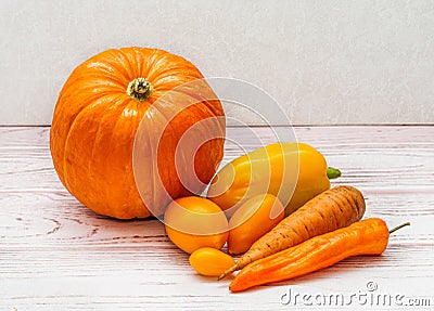Orange vegetables - pumpkin, peppers, carrots and tomatoes. Orange vegetables are a source of carotene and vitamin A Stock Photo