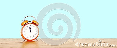 Orange vintage clock on teal background showing nearly 12, last minute concept Stock Photo