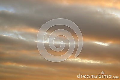 Orange, wavy clouds in the sky Stock Photo