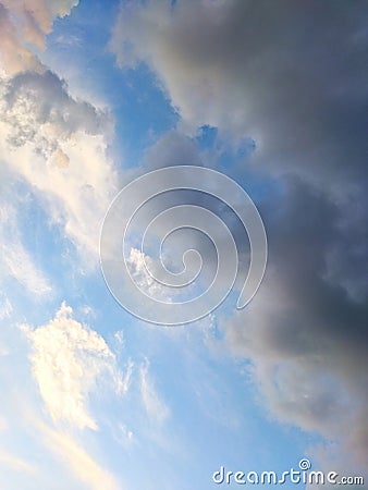 orange white and gray clouds on blue sky at sunset Stock Photo