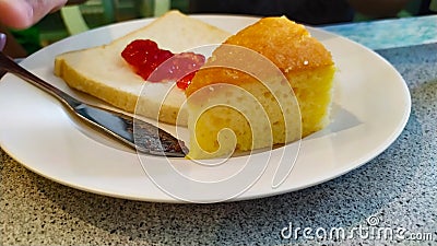 Cake and strawberry jam on bread on dish white very delicious Stock Photo
