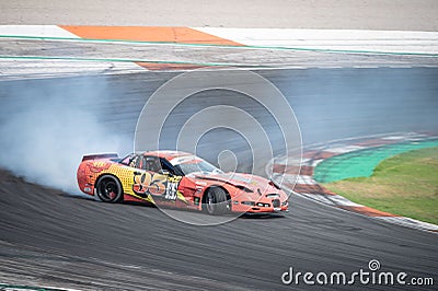Orange yellow Chevrolet Corvette C5 producing smoke on a trail for a drift competition Editorial Stock Photo