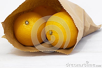 Oranges in a brown paper bag. Environmentally friendly packaging concept Stock Photo