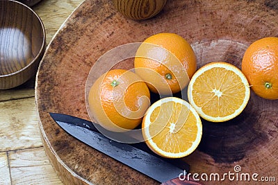 Oranges, fruit knife, cutting board Stock Photo