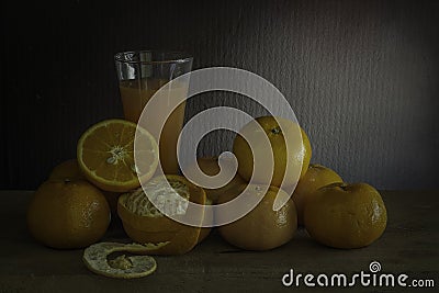 Oranges and glass of juice on a wooden table. / Still life fruit. Stock Photo