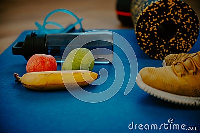 Oranges, granola bars, and a jump rope laid out on the exercise mat. Quick snacks to power up your fitness regimen Stock Photo