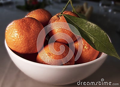 Oranges group freshly picked in a white ceramic bowl Stock Photo