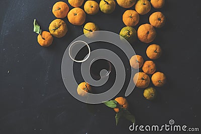 Oranges and two cups of coffee on black background Stock Photo