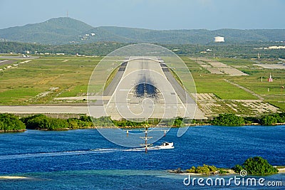Aerial view of the plane runway of Queen Beatrix International Airport by the ocean near Oranjestad, Aruba Stock Photo
