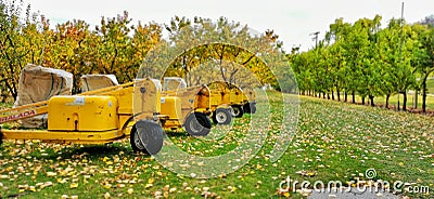 An orchard with agricultural machinery Editorial Stock Photo