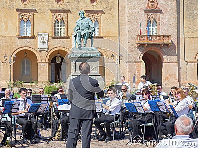 Orchestra Performing Outdoors right in Front of Rocca Pallavicino and the Statue of Giuseppe Verdi, Italian Composer, Parma, Italy Editorial Stock Photo