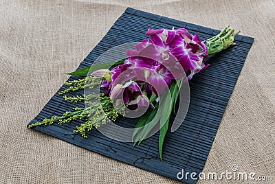 Orchid Bouquet in placemat on sackcloth Stock Photo