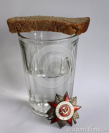 The order `Great Patriotic war` and glass with vodka and piece of bread Editorial Stock Photo