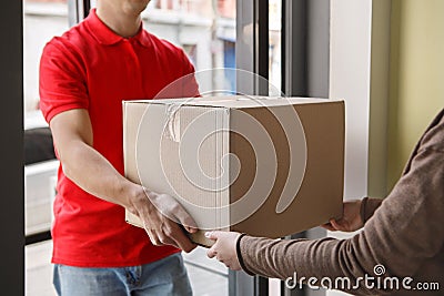 Order received. Woman receives big cardboard box from courier Stock Photo